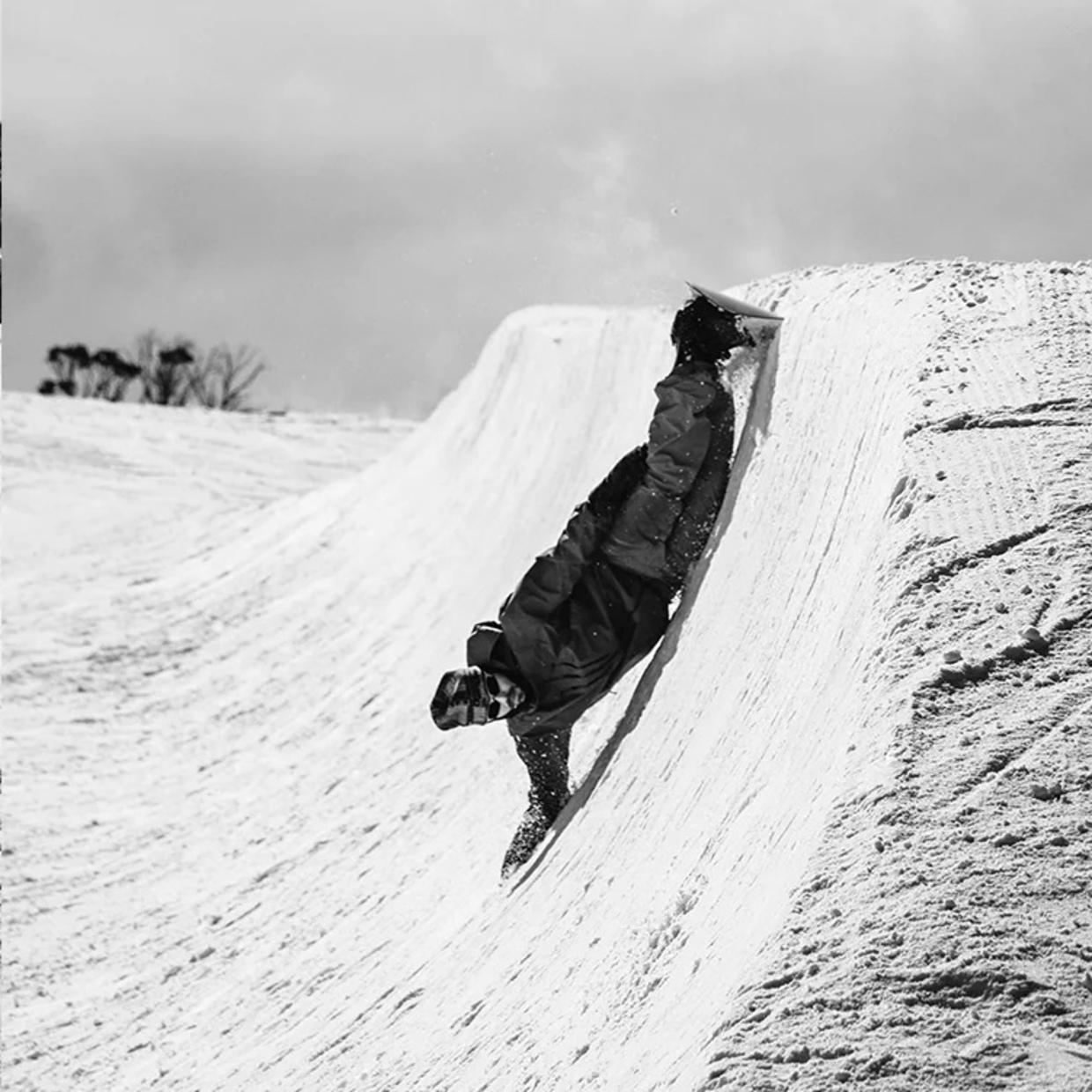 Riders carving on snowboards